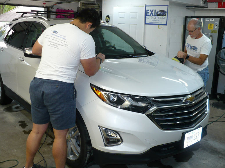 Jar and Steve Polishing Paint with Buffing Pads While Working on Chevrolet Equinox Vehicle