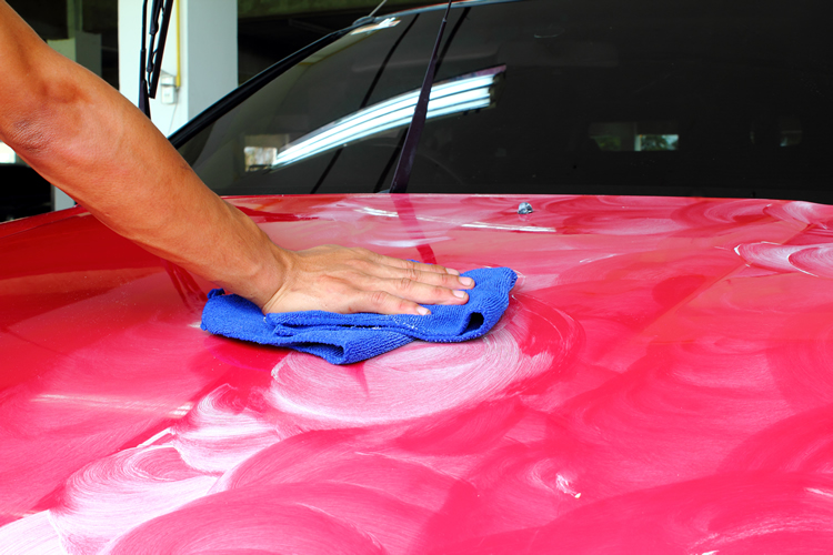 Paint Correction begins with wiping the polish off of the automobile's hood